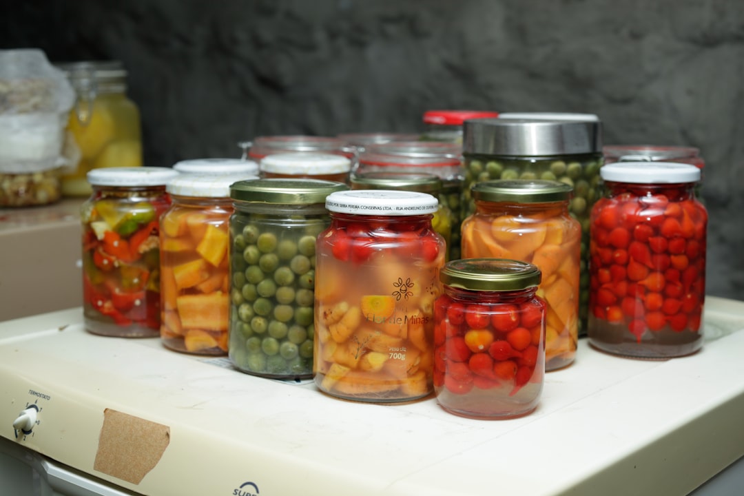Complete Beginner Canning Tools Checklist: What You Actually Need 2 Assorted jars of safely preserved fruits and vegetables arranged on shelves