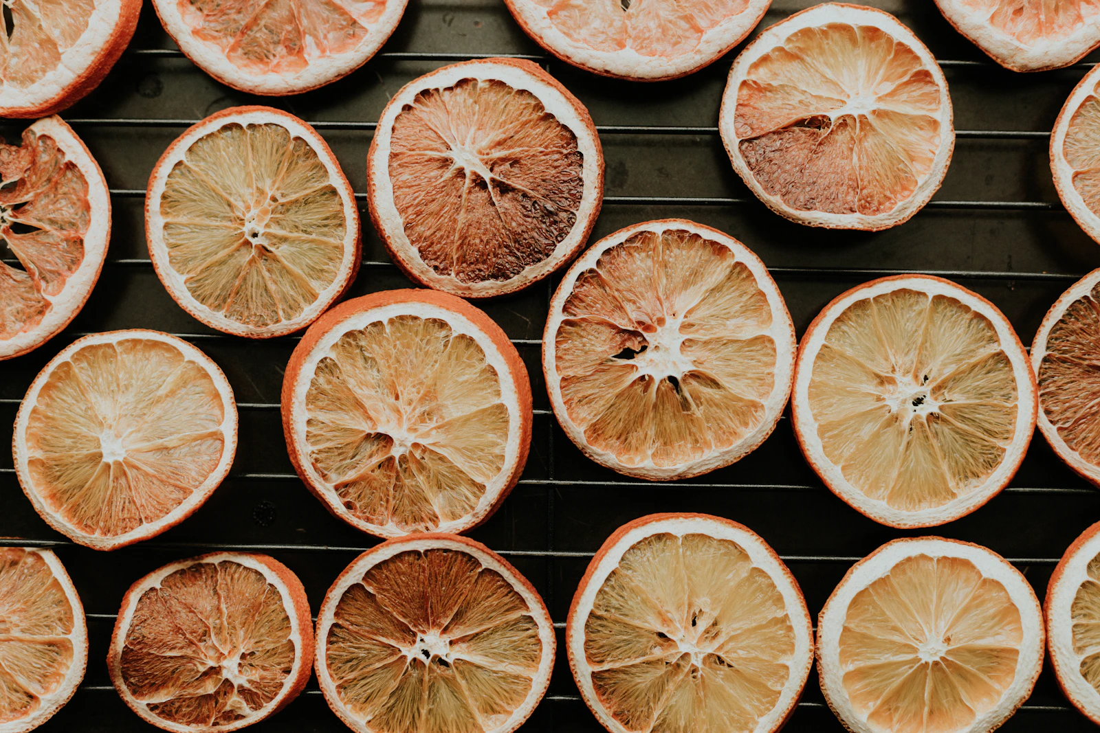 Orange slices arranged on drying racks for home food dehydration