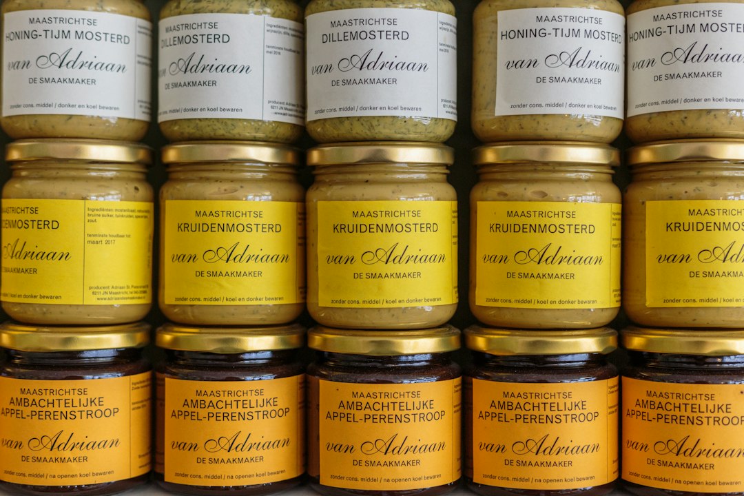 Jars of preserved condiments on a pantry shelf
