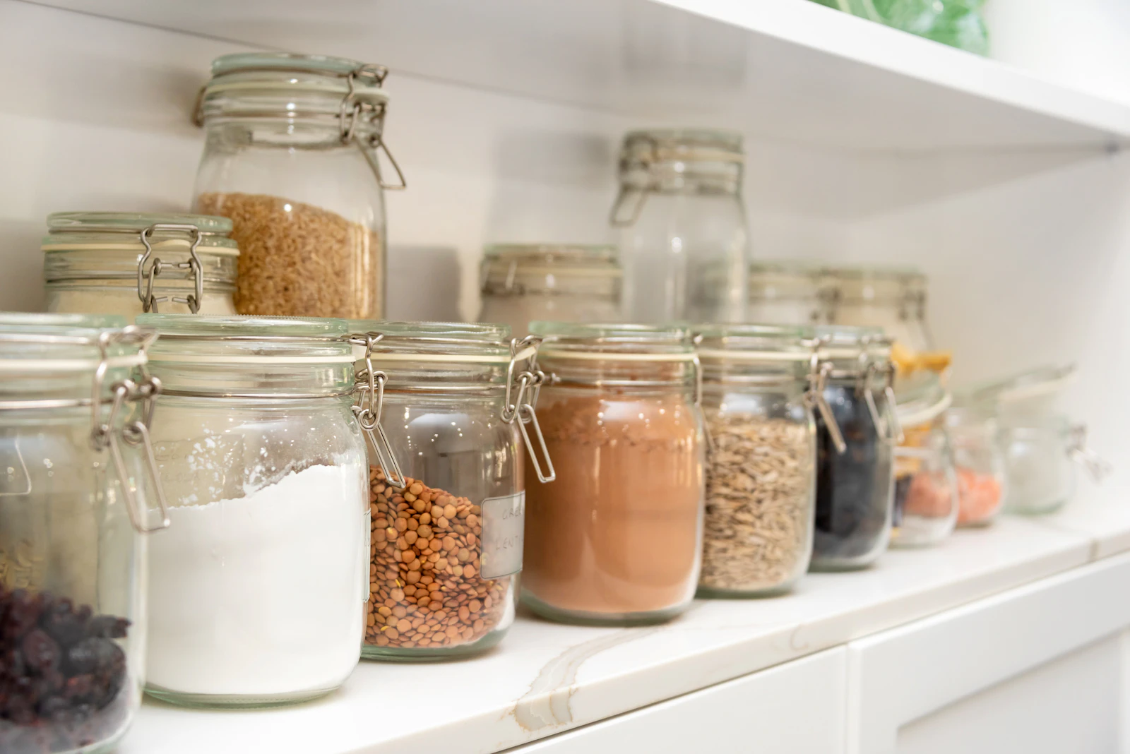 Dry beans grains flour and other pantry staples arranged for home storage