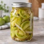 Jar of pickled green tomato wedges and onion